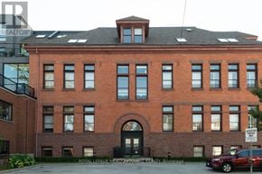 Hamilton (Stinson) condo for rent - A red brick building with a black door and windows.