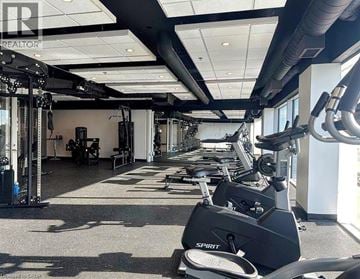 Kitchener condo for rent - A gym with a variety of exercise equipment including treadmills, stationary bikes, and weight machines.