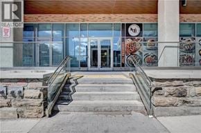 Kitchener condo for rent - A building with a glass door and a sign that says REALTOR.