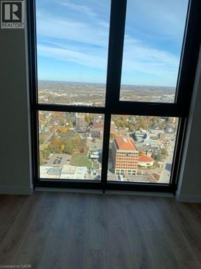 Kitchener condo for rent - A window with a view of a cityscape and buildings.