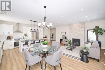 Fort Erie (Ridgeway) apartment for rent - A modern living room with a glass dining table and grey chairs.