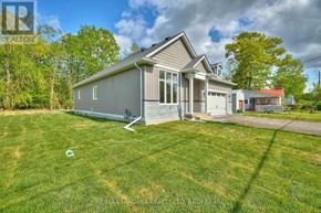 Fort Erie (Ridgeway) apartment for rent - A house with a grey roof and a large lawn in front.