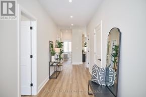 Fort Erie (Ridgeway) apartment for rent - A hallway with a bench and a mirror on the wall.