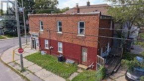 Toronto (Woodbine-Lumsden) duplex for rent - A red brick building with a stop sign in front of it.