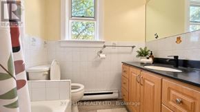 Toronto (Woodbine-Lumsden) duplex for rent - A bathroom with a toilet, sink, and a window.