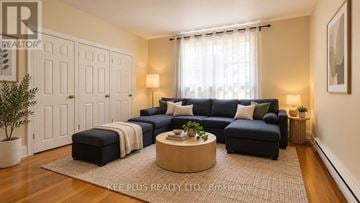 Toronto (Woodbine-Lumsden) duplex for rent - A living room with a dark blue couch, a wooden coffee table, and a rug on the floor.