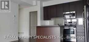 Mississauga (Churchill Meadows) townhouse for rent - A kitchen with dark brown cabinets and stainless steel appliances.