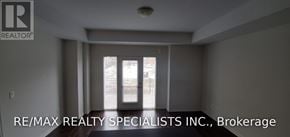 Mississauga (Churchill Meadows) townhouse for rent - A spacious room with a sliding glass door leading to a balcony.