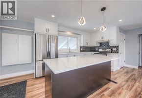 Kitchener apartment for rent - A modern kitchen with a large island in the center.