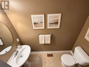 Hamilton (Meadowlands) townhouse for rent - A bathroom with brown walls and a white toilet.