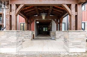 Blue Mountains condo for rent - A wooden covered walkway leads to a building entrance.