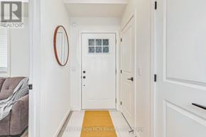 Blue Mountains condo for rent - A hallway with a white door and a round mirror on the wall.