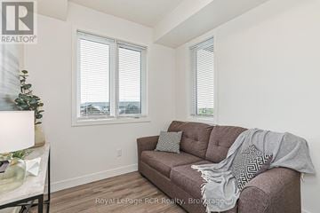 Blue Mountains condo for rent - A living room with a brown couch and a small Christmas tree.