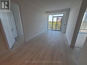 Toronto (Bayview Village) condo for rent - A room with wooden flooring and a large window overlooking a cityscape.