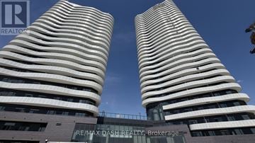 Vaughan (Steeles West Industrial) condo for rent - Two tall buildings with the text RE/MAX DASH REALTY Brokerage in front of them.