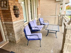 Brampton (Bram West) apartment for rent - Two blue chairs and a table on a patio.