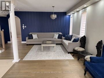 Brampton (Bram West) apartment for rent - A living room with a grey sofa and a white coffee table.