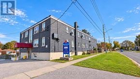 Oshawa (Lakeview) apartment for rent - A building with a blue sign in front of it.