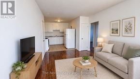 Oshawa (Lakeview) apartment for rent - A living room with a couch, a coffee table, and a television.