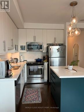 Toronto (Little Portugal) condo for rent - A kitchen with white cabinets and a stainless steel refrigerator.