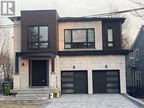 Toronto (Cliffcrest) apartment for rent - A modern two-story house with a black front door and windows.
