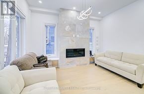 Toronto (Cliffcrest) apartment for rent - A modern living room with a fireplace and a large window.