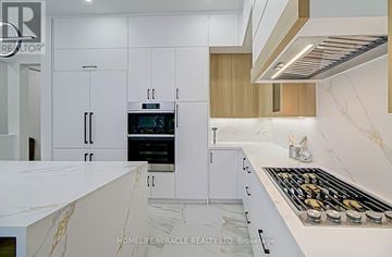Toronto (Cliffcrest) apartment for rent - A modern kitchen with white cabinets and a marble countertop.