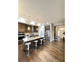 Surrey apartment for rent - A kitchen with a bar and stools in the middle.