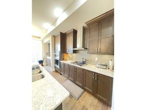 Surrey apartment for rent - A kitchen with brown cabinets and a white countertop.
