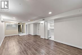 Newmarket (Bristol-London) apartment for rent - A spacious room with wooden flooring and white walls, with a door leading to another room visible in the background.