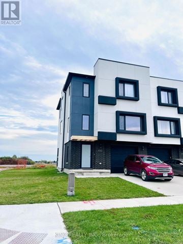 London South (South W) townhouse for rent - A modern two-story building with a red car parked in front.