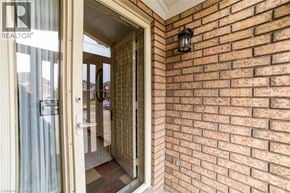Hamilton apartment for rent - A doorway with a glass door and a brick wall.