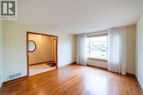 Hamilton apartment for rent - A room with wooden floors and a large mirror on the door.