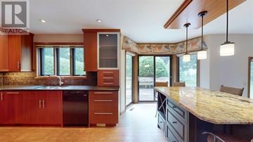 Sault Ste. Marie apartment for rent - A kitchen with wooden cabinets and granite countertops.
