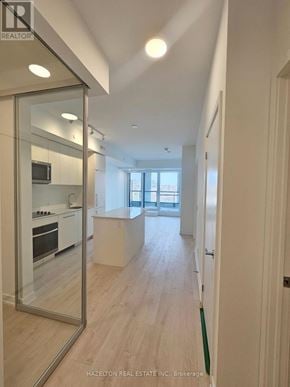 Toronto (Willowdale East) condo for rent - A modern kitchen with a glass door and a wooden floor.