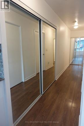 Toronto (Niagara) condo for rent - A hallway with wood floors and white walls.