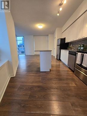 Toronto (Niagara) condo for rent - A kitchen with a white island in the middle of the room.