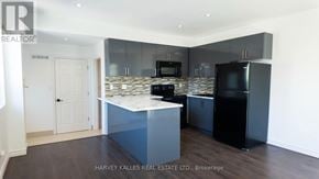 Toronto (Humewood-Cedarvale) multi-family for rent - A modern kitchen with a marble countertop and stainless steel appliances.