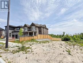 Wasaga Beach apartment for rent - A real estate sign is in front of a newly constructed house.