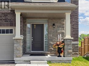 Wasaga Beach apartment for rent - A house with a black door and a stone pillar.