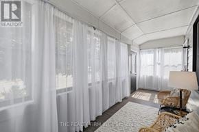 London East (East G) apartment for rent - A well-lit room with a sofa, chair, and a window with curtains.