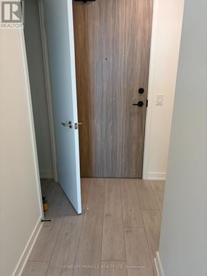 Mississauga (Lakeview) condo for rent - A wooden door with a black handle and a lock is closed.