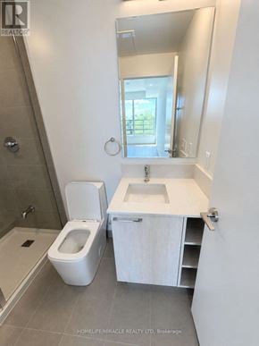 Mississauga (Lakeview) condo for rent - A white bathroom with a toilet, sink, and mirror.