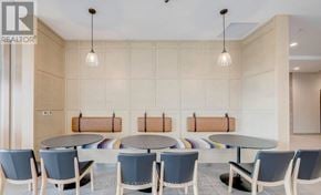 Kitchener condo for rent - A modern dining area with a round table and chairs.