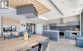 Kitchener condo for rent - A modern kitchen with a dining table and chairs.