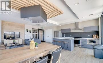 Kitchener condo for rent - A modern kitchen with a dining table and chairs.
