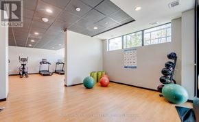 Kitchener condo for rent - A gym with exercise equipment and a calendar on the wall.