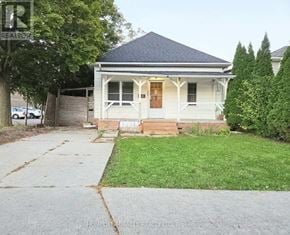 Windsor apartment for rent - A small, white house with a porch and a brown door.