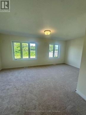 Brant (Brantford Twp) townhouse for rent - A room with carpeted floor and two windows.