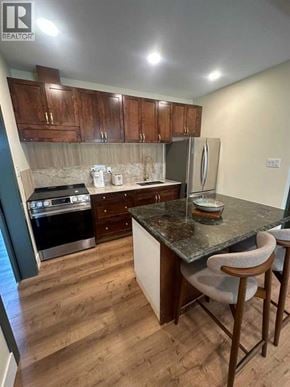 Blairmore apartment for rent - A kitchen with wooden cabinets and a granite countertop.